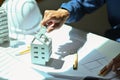 Architect man examining house model while working construction project in a creative office Royalty Free Stock Photo