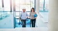 Architect, man and woman on stairs in office for planning, decision or ideas in construction industry. Contractor Royalty Free Stock Photo