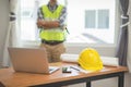 Architect man working with laptop and blueprints,engineer inspection in workplace for architectural plan,sketching a construction Royalty Free Stock Photo