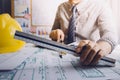 architect man working with laptop and blueprints,engineer inspection in workplace for architectural plan,sketching a construction Royalty Free Stock Photo