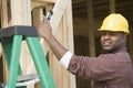 Architect Measuring Level Of Wooden Beam