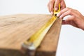 Architect measuring wood with tape