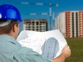 Architect reading technical drawing of construction Royalty Free Stock Photo