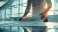 an architect reviews and unrolls blueprints on a sleek table within, modern, office space, with ample copy space for