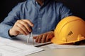 Architect& x27;s workplace with helmet and drawing tools. Man working on blueprint Royalty Free Stock Photo