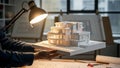 Architect showcasing architectural model design illuminated by drafting lamp in office environment Royalty Free Stock Photo