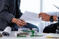 Architect Student Discussion and Meeting About Home Design with Paper Model of Modern House Miniature Sample of Architect Student