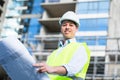 Architect studying floor plan at construction site Royalty Free Stock Photo
