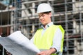 Architect studying floor plan at construction site Royalty Free Stock Photo
