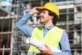 Architect studying floor plan at construction site Royalty Free Stock Photo
