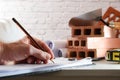 Architect taking notes in office with construction material Royalty Free Stock Photo