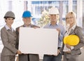 Architect team holding poster in office