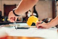 Architect using divider compass working on blueprint. blueprints, ruler, calculator, safety hat and book on the table. Royalty Free Stock Photo