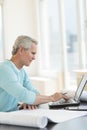 Architect Using Laptop At Desk