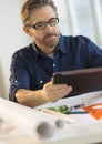 Architect Using Tablet Computer At Desk Royalty Free Stock Photo