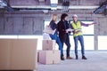 Architect showing house design plans to a young couple Royalty Free Stock Photo