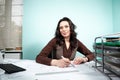 Architect woman at her working desk with blueprints in front Royalty Free Stock Photo