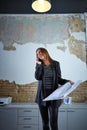 Architect woman talking phone holding plan paper Royalty Free Stock Photo