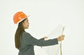Architect woman wearing colorful helmet looking blue print for work in whitre background