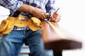 Architect at work. Closeup of architect measuring wood with tape. Royalty Free Stock Photo