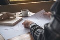 An architect working on an architecture model with shop drawing paper and coffee cup Royalty Free Stock Photo
