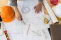 Architect working on blueprint. Architects workplace - architectural project, blueprints, ruler, calculator, laptop and divider co Royalty Free Stock Photo