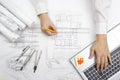 Architect working on blueprint. Architects workplace - architectural project, blueprints, ruler, calculator, laptop and Royalty Free Stock Photo