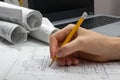 Architect working on blueprint. Architects workplace - architectural project, blueprints, ruler, calculator, laptop and Royalty Free Stock Photo