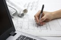 Architect working on blueprint. Architects workplace - architectural project, blueprints, ruler, calculator, laptop and Royalty Free Stock Photo