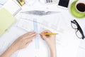 Architect working on blueprint. Architects workplace - architectural project, blueprints, ruler, calculator, laptop and Royalty Free Stock Photo