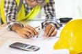 Architect working on blueprint.engineer inspective in workplace - architectural project, blueprints,ruler,calculator,laptop and Royalty Free Stock Photo