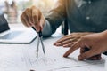 Architect working on blueprint in workplace with partnership and drawing compass Royalty Free Stock Photo