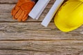 Construction office working with blueprints in the set of protective workwear in yellow hard hat protective gloves Royalty Free Stock Photo