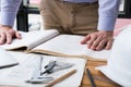 architect working on construction plan at office. engineer inspect blueprint at workplace. man sketching real estate project. Royalty Free Stock Photo