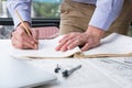 architect working on construction plan at office. engineer inspect blueprint at workplace. man sketching real estate project. Royalty Free Stock Photo
