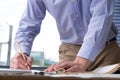 architect working on construction plan at office. engineer inspect blueprint at workplace. man sketching real estate project. Royalty Free Stock Photo