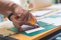 Close up of hands cutting paper Royalty Free Stock Photo