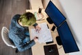 Architect Working On Project In Office. Architect working with blueprints. Young Man with green hair Royalty Free Stock Photo