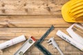 Architect workplace. Project construction blueprints and engineering tools on wooden desk, copy space