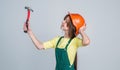 architect in workshop. renovation and repair. using working tool. teen girl in helmet with hammer. child wear hard hat