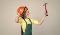 architect in workshop. renovation and repair. using working tool. teen girl in helmet with hammer. child wear hard hat
