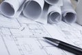 Architect worplace top view. Architectural project, blueprints, blueprint rolls and pen on plans. Construction Royalty Free Stock Photo