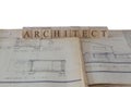 Architect written on wooden blocks on house extension building plans blueprints Royalty Free Stock Photo