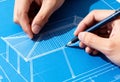 Architect& x27;s hands drawing a construction project on a blueprint. Engineer designing a house plan with a pencil. Architectural Royalty Free Stock Photo