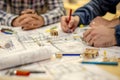 Architects Collaborate, Designing Innovative Building Structures with Detailed Blueprints and 3D Models, Utilizing Pencils and