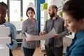 Architects couple holding blueprints in modern architectural office Royalty Free Stock Photo