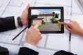 Architects with digital tablet looking at house Royalty Free Stock Photo