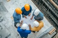 Architects and engineers collaborate on construction site to review documents and workflow processes