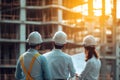 Architects and engineers collaborate on construction site to review plans and workflow processes