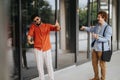 Architects, engineers, and designers collaborate outdoors, discussing a construction project, inspecting a blueprint on Royalty Free Stock Photo